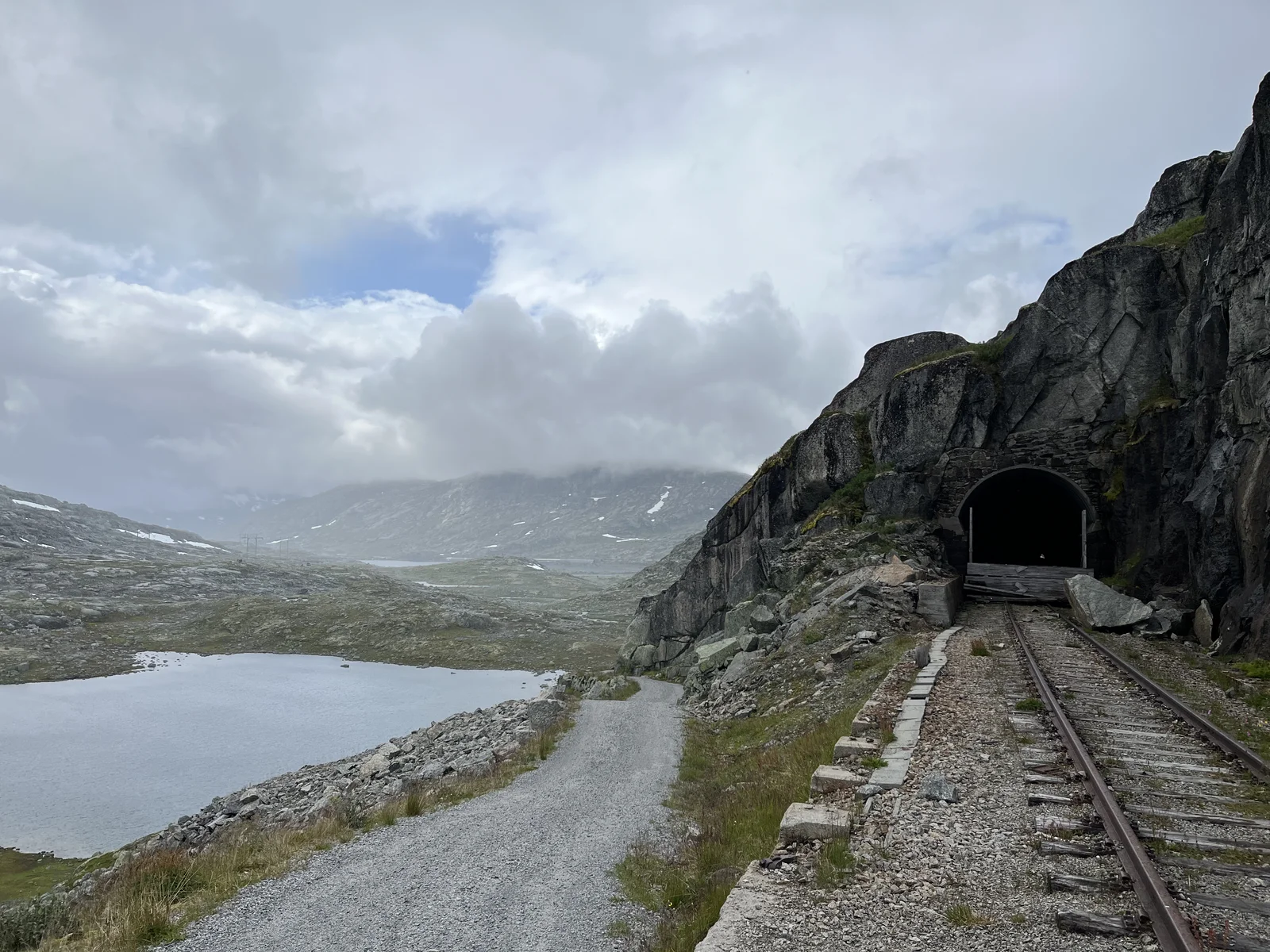 A railway and tunnel beside a Norwegian mountain lake
