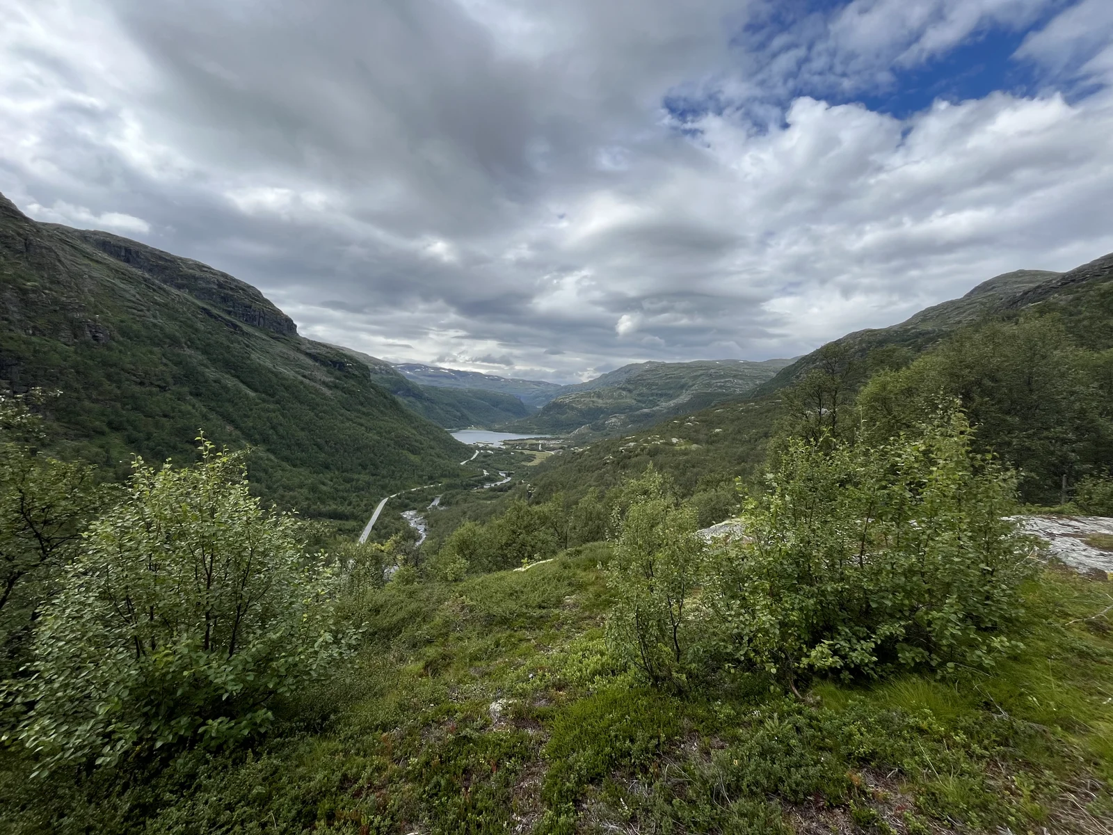 A river winding through a deep green valley in Norway
